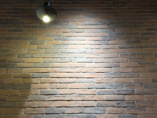 Wall Mural - Brick wall under lighting as an abstract background. Texture