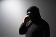 © yta - Phone Scammers, man in a mask with a phone, cyber criminal stealing information, hacker attacking accounts, online theft and fraud