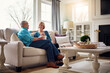 © Reese Coop/peopleimages.com - Senior couple, coffee and talk on couch in conversation, relax or happy memory in home living room. Old man, elderly woman and chat for bonding with care, love or story in retirement on sofa in house