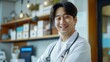 © James - Handsome Korean doctor, smiling, stethoscope, doctor's office at hospital, professional attire, caring demeanor, indoor setting, medical equipment.