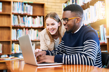 Wall Mural - Woman, student and laptop in library as friends or research, education and exam preparation in university. Man, studying and technology with smile for knowledge, social media and learning on internet