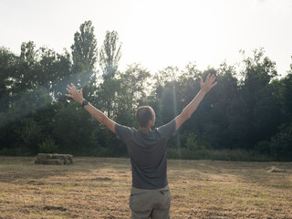 A Man Looking At Sky With Arms Wide Open