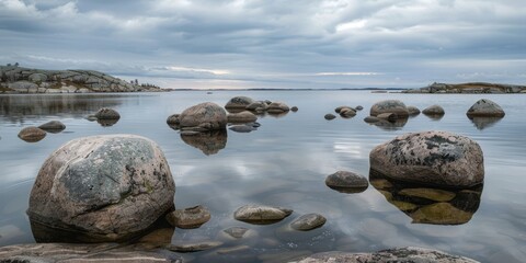 Wall Mural - coastal Sweden, archipelago, rounded worn stones peeking out of gentle coastal water, feeling coldness, yet serene and pretty, award winning photography 