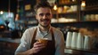 © Generative AI - Smiling male owner wearing apron holding coffee cup at cafe : Generative AI