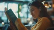 © Generative AI - Portrait of beautiful woman reading a book while relaxing in the cafe : Generative AI