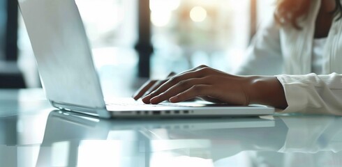 Female hands working on a laptop in a business office using modern technology.