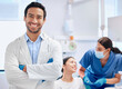 © Maass/peopleimages.com - Portrait, dentist and nurse for oral health, dental care and hygiene in office or consultation in clinic. Man, arms crossed and smile as medic or doctor in hospital for treatment of teeth or mouth