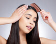 © Maass/peopleimages.com - Woman, comb and hair care in studio for hairdresser, haircut and beauty salon on white background. Girl, grooming and confident with healthy texture, wellness or treatment with growth transformation