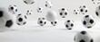© STOCKYE STUDIO - Soccer balls suspended in mid-air against a bright white studio backdrop, creating a dynamic and visually striking composition