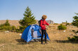 © Malik Nalik - A male traveler solo camping in the mountain forest adventure travel.
