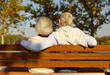 © Studio Romantic - Back view of mature senior couple family sitting on the bench in park and hugging enjoying retirement and spending time together in nature. Elderly people love, care and relationship concept.