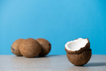 Wall Mural - Coconuts on blue background, space for text