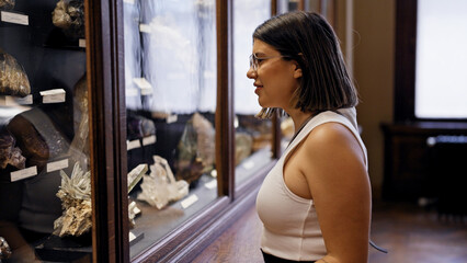 Wall Mural - Young beautiful hispanic woman visiting geological exhibition at Natural History Museum in Vienna