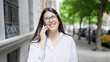 © Krakenimages.com - Young beautiful hispanic woman smiling happy speaking on the phone in the streets of Madrid