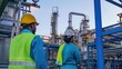 © MAGNIFIER - Engineer men,women standing back to control work, oil refinery.