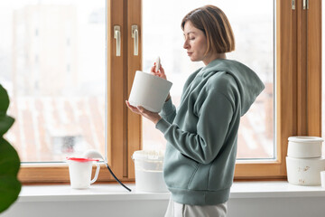 Close-up Image portrait of female ceramic artist working with clay mug and making Ceramic Product. Professional Ceramic Artist makes handcrafted products. Small business and hobby concept