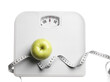 © New Africa - Scale, measuring tape and fresh apple isolated on white, top view