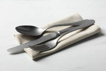 Wall Mural - Stylish cutlery set and napkin on white table
