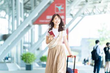 空港でパスポートを持つ旅行中の女性