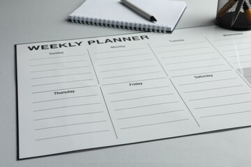 Wall Mural - Timetable. Planner, notebook and pen on grey table, closeup