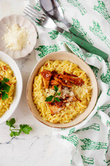 Poster - Orzotto with chanterelles, Parmesan cheese and parsley in a deep ceramic bowl.