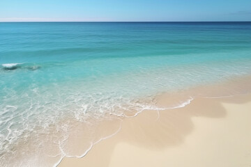 Wall Mural - Crystal clear turquoise water meeting white sand beach on sunny day
