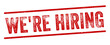 © Hasriani - We're Hiring Red Watermark Stamp isolated on transparent background. Text caption between parallel lines with grunge design style.