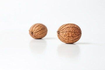 Wall Mural - Two Whole Walnuts on a White Background