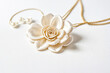 © Rysak - White Silk Flower with Pearl Necklace on White Background