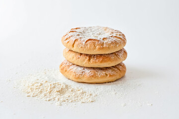 Sticker - Three Homemade Doughnuts in Powdered Sugar on White Background