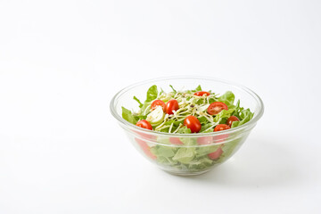 Wall Mural - Fresh Salad in Glass Bowl on White Background