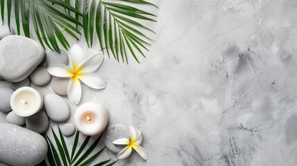 Spa theme with white stone backdrop palm leaves flower candle and grey stones from above with space for text