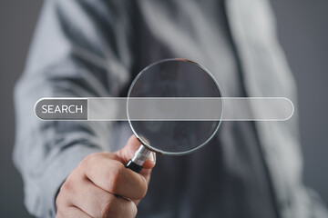 Wall Mural - man's hand holding magnifying glass searching for information. using search console with your websit