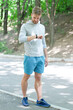 © be free - Man runner with fitness gadget. Smartwatch for fitness. Sporty fit man with sport equipment check time on smartwatch. Man tracking fitness results in sportswear outdoor. Use mobile application