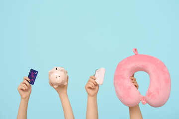 Sticker - Female hands with credit card, piggy bank, cushion and wallet on blue background. Travel concept