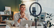 © WesSide/peopleimages.com - Man, influencer and home with smartphone for social media or online vlog and live streaming. Content creator, happy and smile for podcast as university student for educational talk and motivation