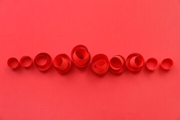 Wall Mural - Red paper circles on color background, closeup