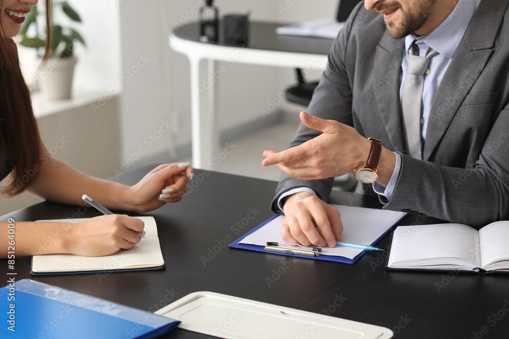 Human resources manager interviewing female applicant at table in office, closeup