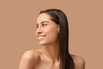 Poster - Young dark-haired woman on beige background