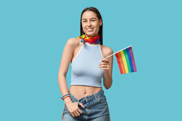 Poster - Beautiful young happy woman with piercing navel and LGBT flag on blue background