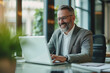 © Varitnan - businessman working on laptop for video conference meeting joyful and happy photo