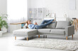 © Pixel-Shot - Young pretty woman lying and chatting with mobile phone on sofa in stylish living room