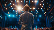 © Gita - A speaker addressing an audience on stage, illuminated by bright lights, capturing the energy and focus of a public speaking event or conference.