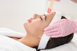 © Pixel-Shot - Beautician with wax removing woman's hair in salon, closeup