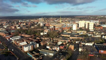 Wall Mural - Aerial footage of the town centre of Wakefield in West Yorkshire UK showing the whole of the town centre with shops, roads and traffic around the city centre and a large church omn a cloudy day.