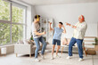 © Pixel-Shot - Teenage boy with his dad and grandfather in headphones dancing at home