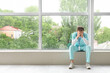 © Pixel-Shot - Tired medical intern near window in clinic