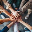 © Tatiana - A group of people are holding hands in a circle