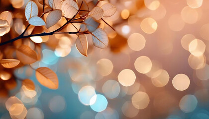 Branch of small copper colored leaves on shimmering blurred background. Bright bokeh effect.