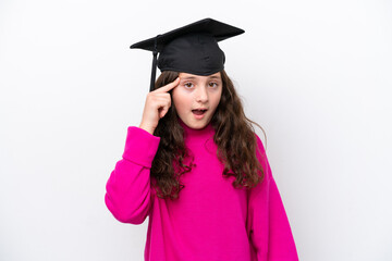 Wall Mural - Little student girl wearing a graduated hat isolated on pink background intending to realizes the solution